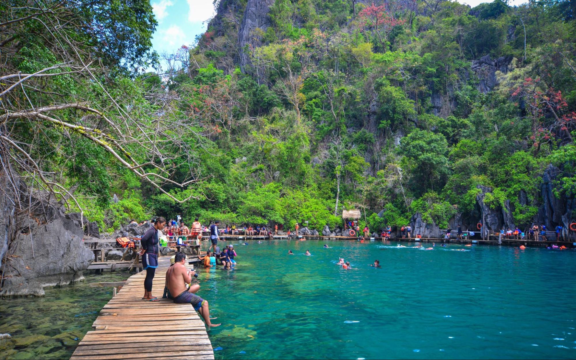 Tourists enjoy on Barracuda Lake in Coron Island, Philippines