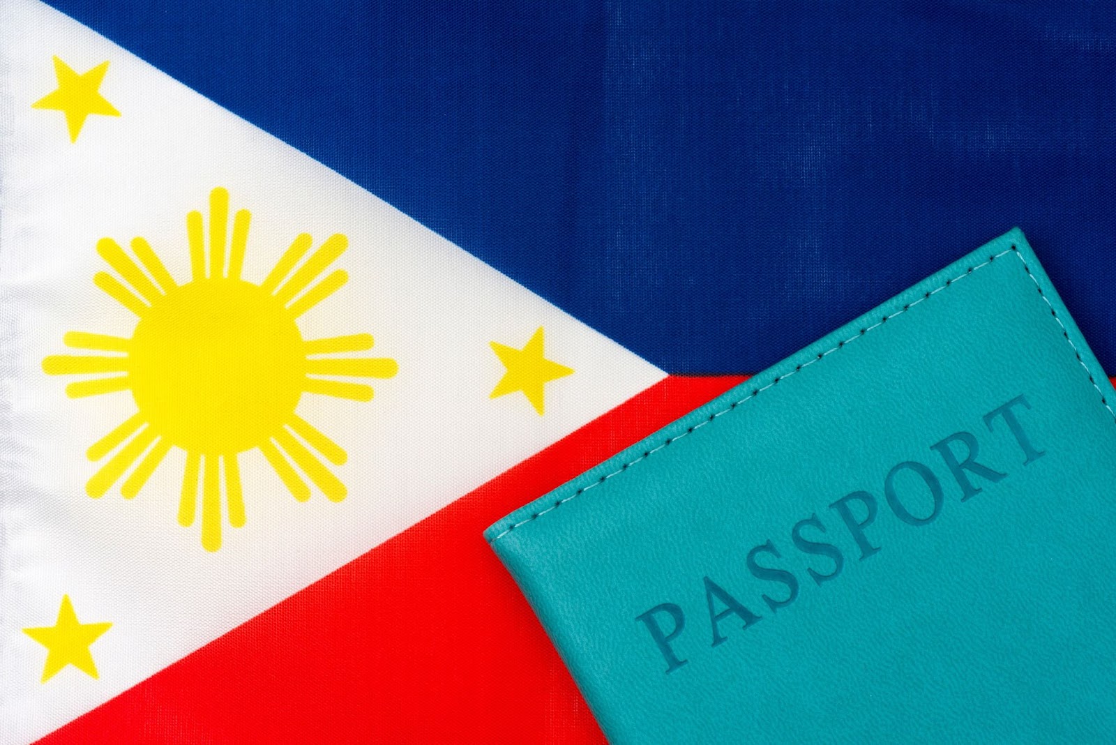 Against the background of the flag of the Philippines is a passport